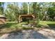 Outdoor gazebo with hanging plants and flowers in the yard at 7182 Griffin Rd, Brooksville, FL 34601