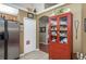 Kitchen with stainless steel refrigerator and built-in red display cabinet at 7182 Griffin Rd, Brooksville, FL 34601