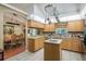 Open kitchen with tile floors, island, and view of dining room at 7182 Griffin Rd, Brooksville, FL 34601