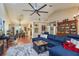 Open-concept living space with a large sectional, hardwood floors, and a combined living and dining area at 7182 Griffin Rd, Brooksville, FL 34601