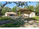 Exterior shot of home, outbuilding, and covered area, all with neutral exteriors on a sunny day at 7182 Griffin Rd, Brooksville, FL 34601