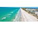Breathtaking aerial view of a pristine beach with crystal clear water and inviting white sands along beach homes at 8066 Brentwood Rd # 8066, Seminole, FL 33777