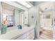 Bright bathroom featuring a white vanity, a large mirror, and a view into the adjacent shower and bedroom at 8066 Brentwood Rd # 8066, Seminole, FL 33777