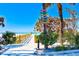 Scenic beach access point with tropical foliage, clear skies, and a glimpse of the ocean horizon at 8066 Brentwood Rd # 8066, Seminole, FL 33777