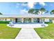 Attractive clubhouse exterior with stone accents, a large patio, and manicured landscaping, perfect for community gatherings at 8066 Brentwood Rd # 8066, Seminole, FL 33777