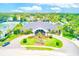 Aerial of community clubhouse with manicured landscaping, circular driveway, and convenient parking at 8066 Brentwood Rd # 8066, Seminole, FL 33777