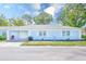 Charming single-story home with a light blue exterior, attached garage, and well-manicured lawn at 8066 Brentwood Rd # 8066, Seminole, FL 33777