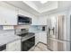 Bright kitchen features stainless steel appliances, white cabinetry and modern countertops at 8066 Brentwood Rd, Seminole, FL 33777