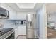 Bright kitchen featuring stainless steel refrigerator, white cabinets, and a skylight at 8066 Brentwood Rd # 8066, Seminole, FL 33777