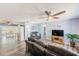 Comfortable living room with gray wood-look floors and a flat-screen TV entertainment center at 8066 Brentwood Rd # 8066, Seminole, FL 33777