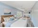 Relaxing bedroom with soft blue walls, light wood floors, and a sitting area near the window at 8066 Brentwood Rd # 8066, Seminole, FL 33777