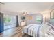 Bedroom with ceiling fan, ensuite access, view to enclosed porch at 8066 Brentwood Rd # 8066, Seminole, FL 33777