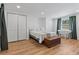 Inviting bedroom with wood floors, a comfortable bed, and ample closet space at 828 20Th S Ave, St Petersburg, FL 33705