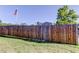 Fenced backyard with grass and an American flag at 9420 Kiowa Dr, New Port Richey, FL 34654