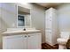 Bright bathroom with white vanity, matching mirror, and coordinating cabinet at 9420 Kiowa Dr, New Port Richey, FL 34654
