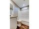 Bright bathroom featuring a single vanity, mirror, and a pristine white shower-tub combination at 9420 Kiowa Dr, New Port Richey, FL 34654