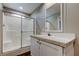 Bright bathroom featuring a glass shower enclosure, and a white vanity with matching mirror at 9420 Kiowa Dr, New Port Richey, FL 34654