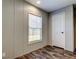 Bright bedroom featuring a window for natural light and wood-look flooring at 9420 Kiowa Dr, New Port Richey, FL 34654