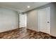 Bedroom with wood-look flooring, ensuite bath, and neutral paint scheme at 9420 Kiowa Dr, New Port Richey, FL 34654