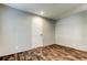 Neutral bedroom featuring wood-look floors and a white interior door at 9420 Kiowa Dr, New Port Richey, FL 34654