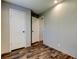 Simple bedroom with wood-look flooring, natural light, and closet at 9420 Kiowa Dr, New Port Richey, FL 34654