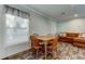 Cozy dining area with wooden table set, large window, and wood-look flooring adjacent to the living area at 9420 Kiowa Dr, New Port Richey, FL 34654