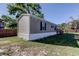 Charming single-story home with gray siding and white trim, nestled on a spacious lot with a well-kept lawn at 9420 Kiowa Dr, New Port Richey, FL 34654