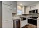 Elegant kitchen featuring stainless steel appliances, including a dishwasher, microwave, and oven at 9420 Kiowa Dr, New Port Richey, FL 34654