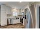 Modern kitchen featuring stainless steel appliances, white cabinets, a farmhouse sink, and elegant countertops at 9420 Kiowa Dr, New Port Richey, FL 34654