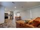 Open concept living area with stainless steel appliances, wood-look floors, and a comfortable brown sectional at 9420 Kiowa Dr, New Port Richey, FL 34654