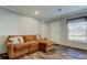 Inviting living room with cozy brown sectional sofa, natural light, and wood-look floors at 9420 Kiowa Dr, New Port Richey, FL 34654