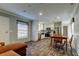 Open-concept living space featuring modern flooring connecting the living, dining, and kitchen areas at 9420 Kiowa Dr, New Port Richey, FL 34654
