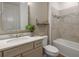 Neutral bathroom featuring a sleek vanity, a modern mirror, and a tiled shower/tub, combining style and functionality at 9825 Autumn Ridge Ave, Riverview, FL 33578