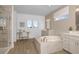 Luxurious bathroom with a soaking tub, a glass-enclosed shower, and a dual vanity offering a spa-like retreat at 9825 Autumn Ridge Ave, Riverview, FL 33578