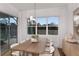 Elegant dining area with sliding glass doors, a wood table, and neutral decor at 9825 Autumn Ridge Ave, Riverview, FL 33578