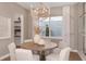Cozy dining room features a round wood table, stylish lighting, and neutral color scheme at 9825 Autumn Ridge Ave, Riverview, FL 33578