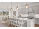 Modern kitchen features a large island with bar seating, pendant lights, and stainless steel appliances at 9825 Autumn Ridge Ave, Riverview, FL 33578