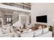 Bright living room boasts a large TV, comfortable seating, and stylish decor at 9825 Autumn Ridge Ave, Riverview, FL 33578