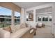 Bright and airy living room featuring modern decor, large windows, and seamless access to the bedroom suite, enhancing the open layout at 9825 Autumn Ridge Ave, Riverview, FL 33578