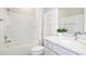 This bathroom features a single sink vanity, with a shower and bathtub combo, and bright white finishes at 9827 Crescent Moon Dr, Riverview, FL 33578