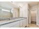 Bathroom featuring double vanities, granite countertops, a large mirror, and a tiled walk-in shower at 9832 Crescent Moon Dr, Riverview, FL 33578