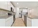 Well-equipped kitchen showcases stainless steel appliances, granite counters, and white cabinets at 9832 Crescent Moon Dr, Riverview, FL 33578
