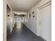 Long hallway with multiple doors and wall lighting, leading to the units at 9940 47Th N Ave # 210, St Petersburg, FL 33708