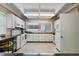 Functional kitchen featuring white cabinetry, essential appliances, and ample counter space at 9940 47Th N Ave # 210, St Petersburg, FL 33708