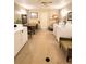 Well lit laundry room with multiple machines, table and seating area at 9940 47Th N Ave # 210, St Petersburg, FL 33708