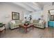 Comfortable living room with stylish striped sofas, a coffee table, and natural lighting at 9940 47Th N Ave # 210, St Petersburg, FL 33708