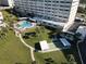Condo complex featuring pool, shuffleboard, lush landscaping and a waterfront view at 100 Bluff View Dr # 502C, Belleair Bluffs, FL 33770
