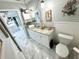 Bathroom features stylish decor, a vessel sink on a granite countertop, and a marble-tiled floor at 100 Bluff View Dr # 502C, Belleair Bluffs, FL 33770