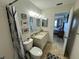 Cozy bathroom with shower, toilet, vanity with granite countertop, and view into bedroom at 100 Bluff View Dr # 502C, Belleair Bluffs, FL 33770