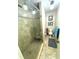 Bathroom with walk-in shower featuring glass door, bench, tiled surround, and adjacent toilet area at 100 Bluff View Dr # 502C, Belleair Bluffs, FL 33770